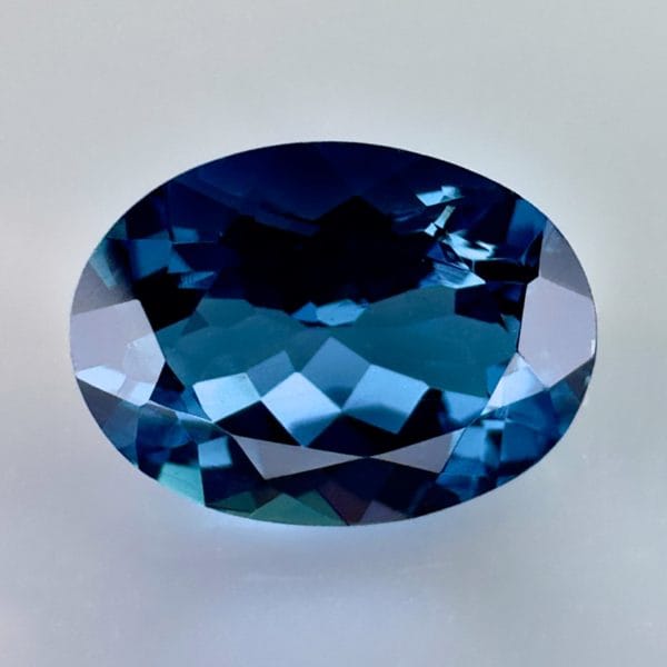 High quality 3.22ct oval shaped London Blue Topaz with a deep blue hue, luminous brilliance and excellent clarity - perfect for fine jewelry designs.