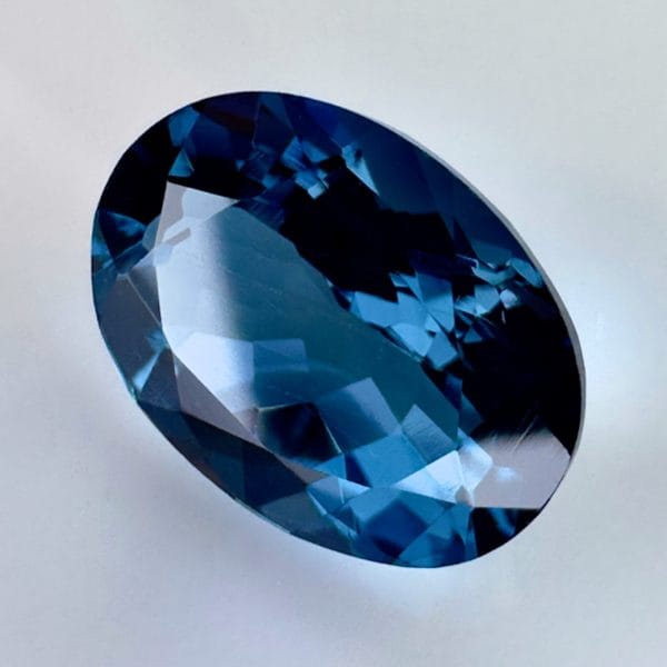 High quality 3.22ct oval shaped London Blue Topaz with a deep blue hue, luminous brilliance and excellent clarity - perfect for fine jewelry designs.