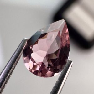 Pink tourmaline gemstone, 0.58 carat, pear-shaped cut, rare salmon pink color, beautiful clarity, and brilliant shine.